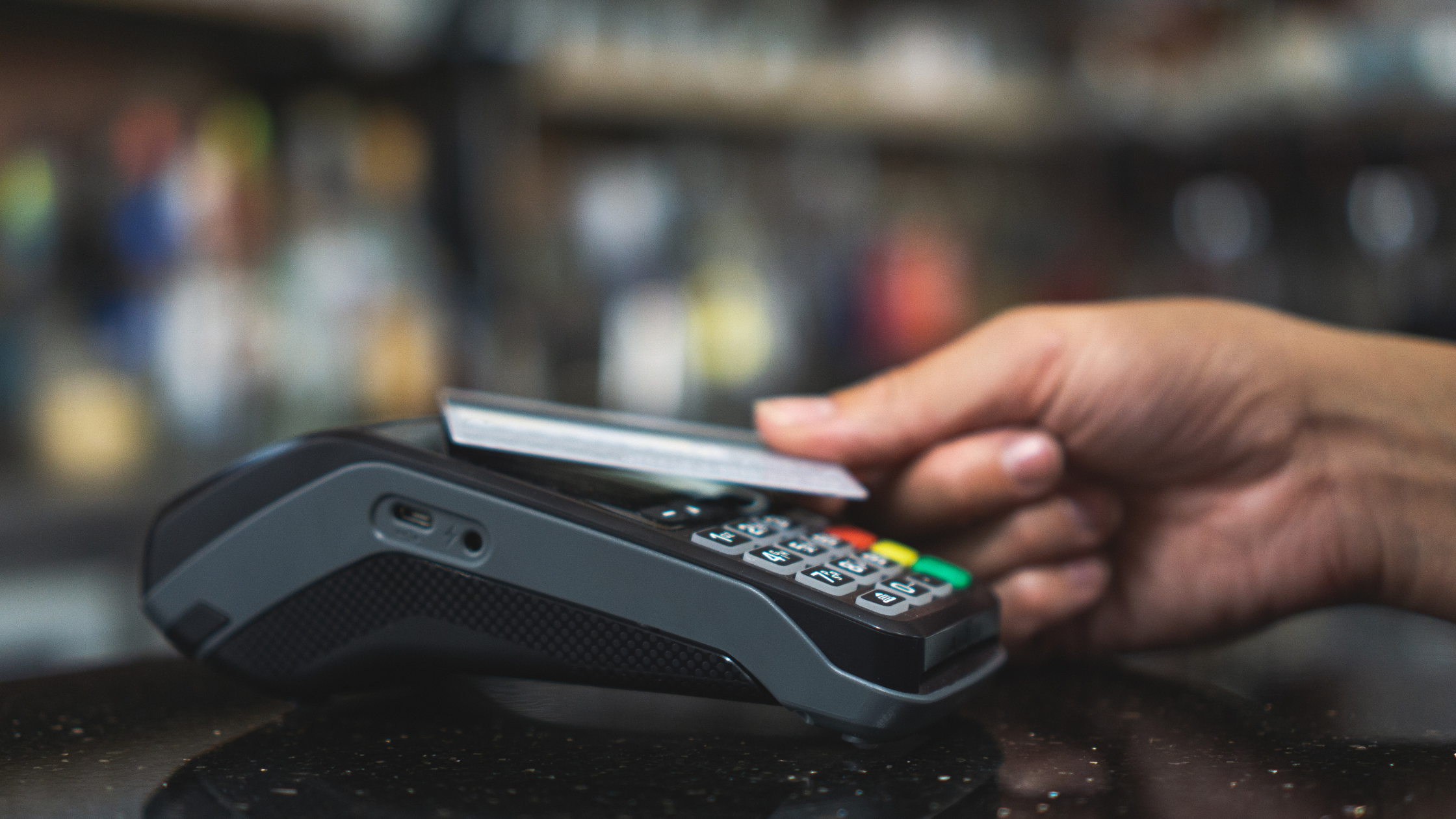 Tapping a debit card toon a point of sale device to pay for services